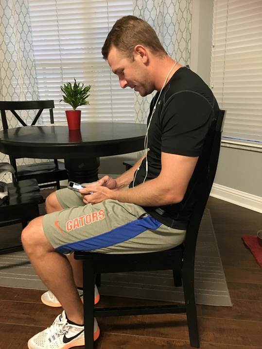 man using mobile device with forward head posture. Bad neck posture