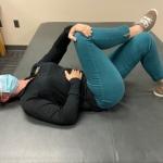 woman doing Sciatic Nerve Stretch grabbing knee