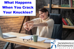Image of a happy woman cracking her knuckles at a desk. JOI Rehab