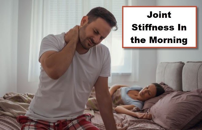 Image of a man grabbing his neck in the morning with stiffness as he gets out of bed