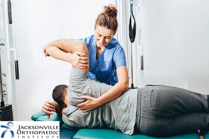 Physical Therapist with patient on table. JOI Rehab