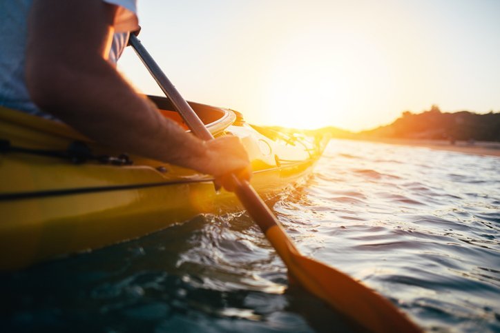 person using a paddle for kayaking